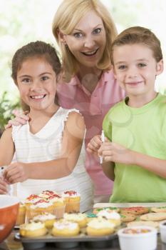 Royalty Free Photo of a Woman and Two Children Baking