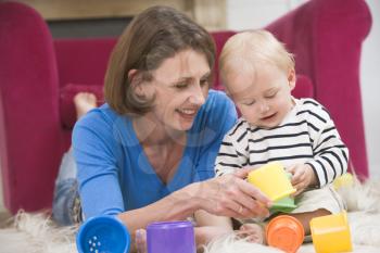 Royalty Free Photo of a Mother Playing With Her Baby