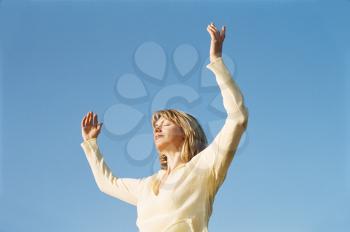 Royalty Free Photo of a Woman With Her Arms Outstretched