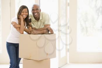 Royalty Free Photo of a Couple Leaning on a Box