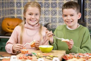 Royalty Free Photo of a Brother and Sister Making Halloween Treats