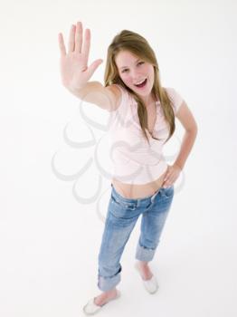 Teenage girl with hand up smiling