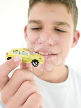 Royalty Free Photo of a Boy Holding a Toy Car