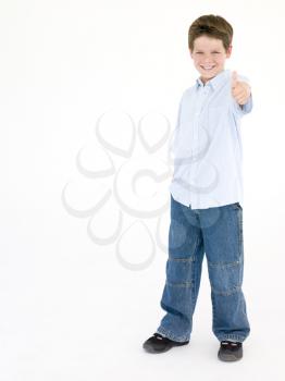 Young boy giving thumbs up smiling