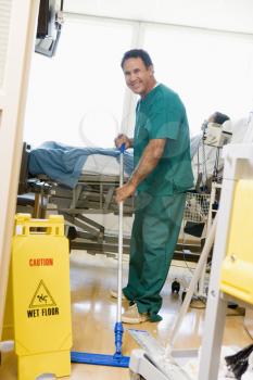 Royalty Free Photo of an Orderly Mopping the Floor