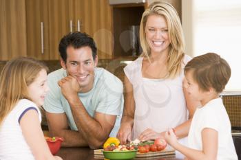 Royalty Free Photo of a Family Cutting Vegetables