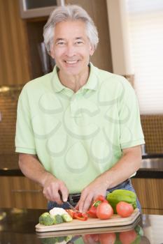 Royalty Free Photo of a Man Chopping Vegetables