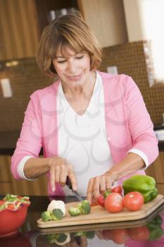 Royalty Free Photo of a Woman Chopping Vegetables