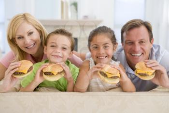 Royalty Free Photo of a Family Eating Cheeseburgers in the Living Room