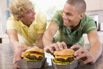 Royalty Free Photo of Boys Eating Burgers