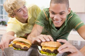 Royalty Free Photo of Boys Eating Burgers