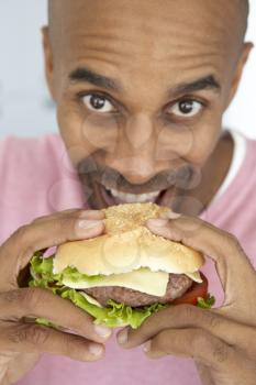 Royalty Free Photo of a Man Eating a Burger