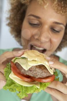 Royalty Free Photo of a Woman Eating a Burger
