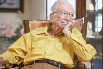 Royalty Free Photo of a Man Relaxing in an Armchair