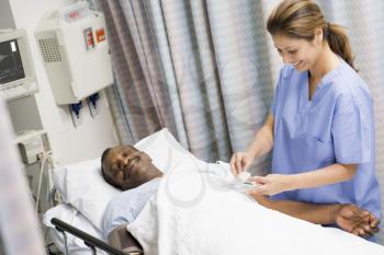 Royalty Free Photo of a Nurse Caring for a Patient