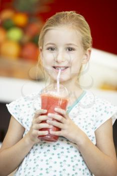 Royalty Free Photo of a Little Girl With a Berry Smoothie
