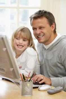 Royalty Free Photo of a Father and Daughter Using the Computer
