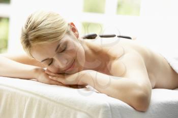 Royalty Free Photo of a Young Woman Having a Hot Stone Massage