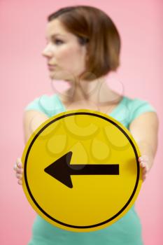 Royalty Free Photo of a Woman Holding an Arrow Sign