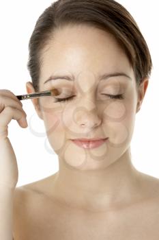 Royalty Free Photo of a Girl Applying Eye Shadow