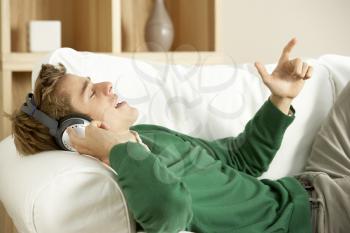 Royalty Free Photo of a Young Man Listening to Music at Home