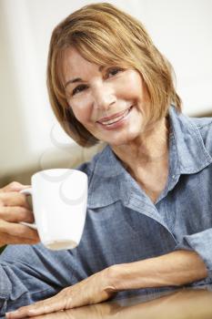 Mid age woman drinking coffee