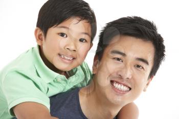 Studio Shot Of Chinese Father And Son