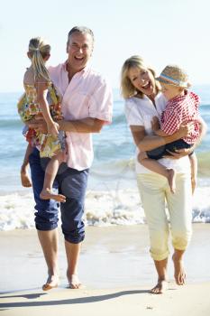 Grandparents And Grandchildren Enjoying Beach Holiday