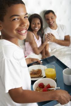 Son Bringing Parents Breakfast In Bed