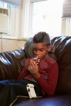 Boy Discovering Parent's Pack Of Cigarettes At Home
