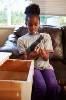 Girl Playing With Parent's Gun She Has Found At Home