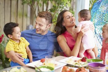 Family Enjoying Outdoor Meal At Home