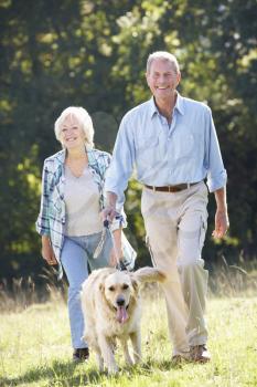 Senior couple walking dog