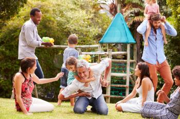 Adults and kids having fun playing in a garden