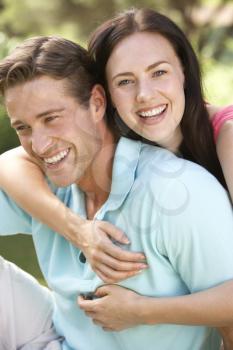 Portrait Of Young Couple Relaxing In Countryside