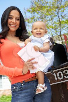 Hispanic Mother And Baby Checking Mailbox
