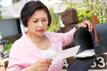 Worried Senior Hispanic Woman Checking Mailbox