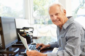 Senior man working on computer at home
