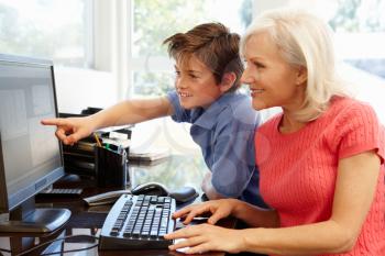 Mid age woman and grandson using computer