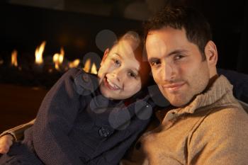 Portrait father and daughter by firelight