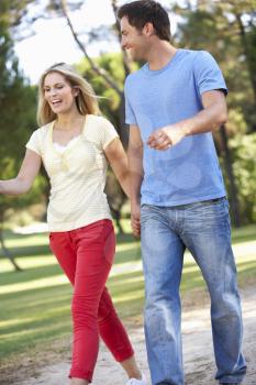 Couple Walking In Park Together