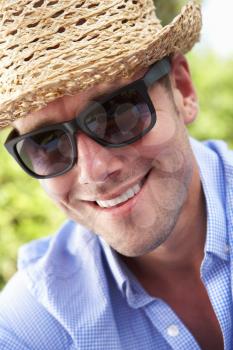 Head And Shoulders Portrait Of Smiling Man With Sun Hat