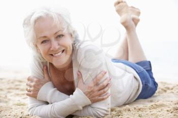 Senior Woman Relaxing On Beach