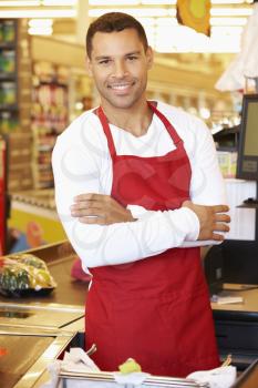 Male Cashier At Supermarket Checkout