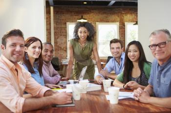 Portrait Of Female Boss With Team In Meeting