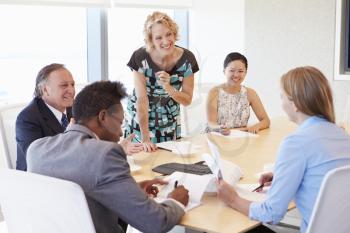 Five Businesspeople Having Meeting In Boardroom