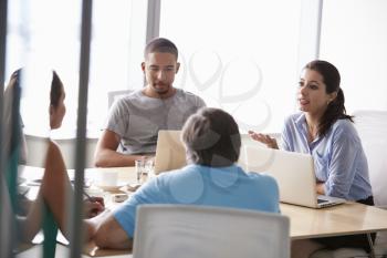 Five Businesspeople Having Meeting In Boardroom