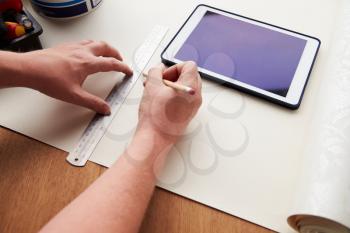 Man Plans Design Project Using Application On Digital Tablet