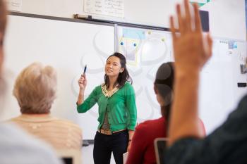 Teacher in front of students at an adult education class