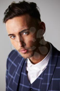 Close-up portrait of inquisitive young man wearing a suit